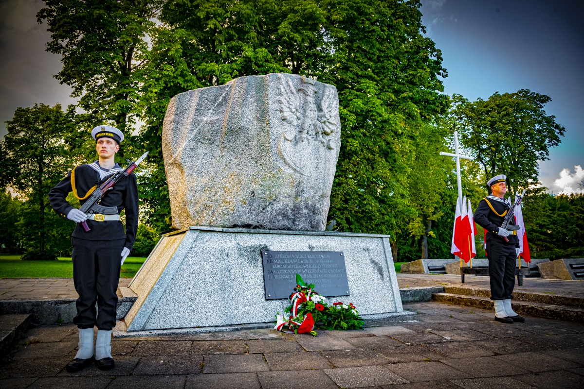 Żołnierze marynarki wojennej pod obeliskiem poświęconym bohaterom walk z faszyzmem niemieckim
